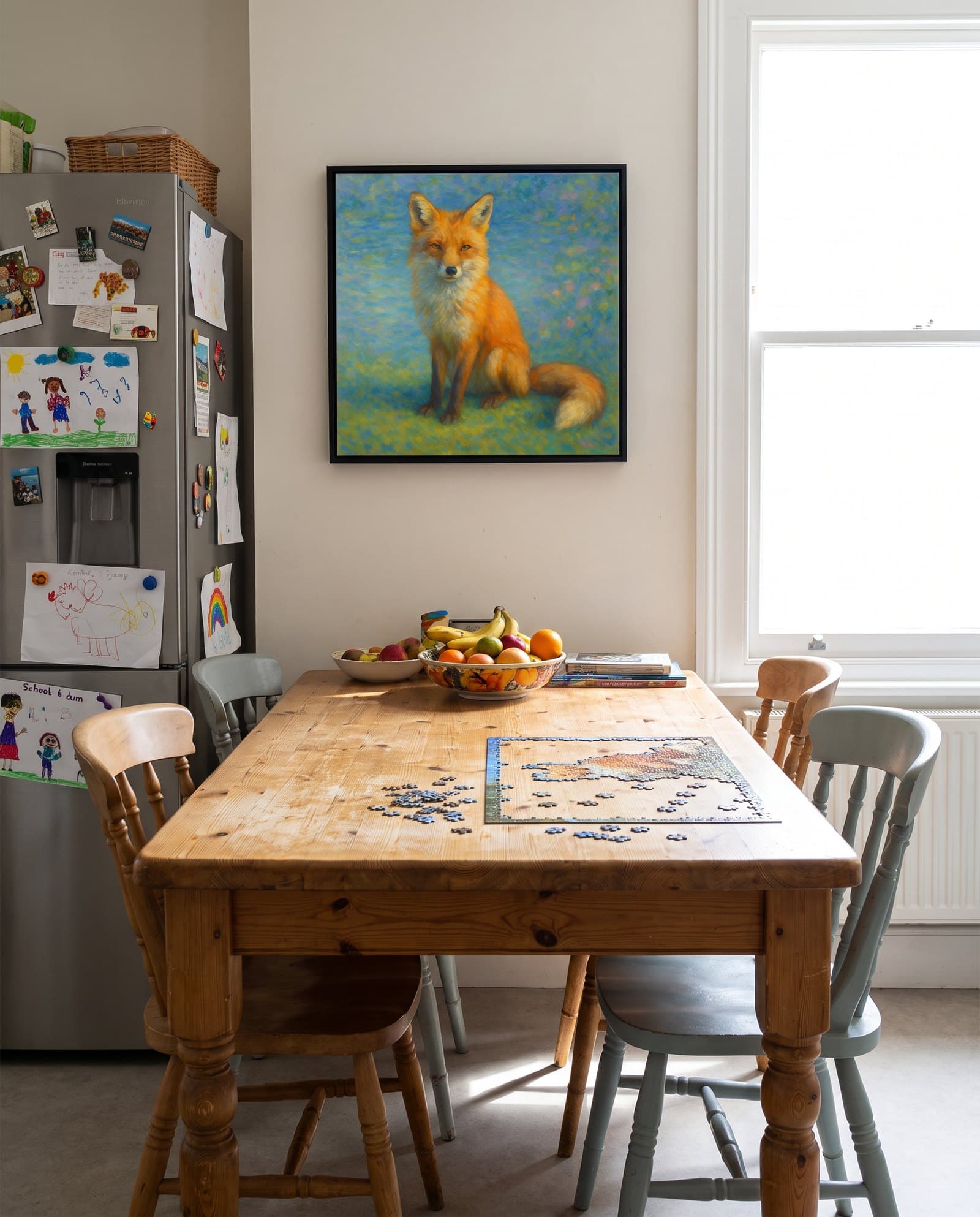 A painted fox portrait on canvas hanging in a family kitchen above a pine table